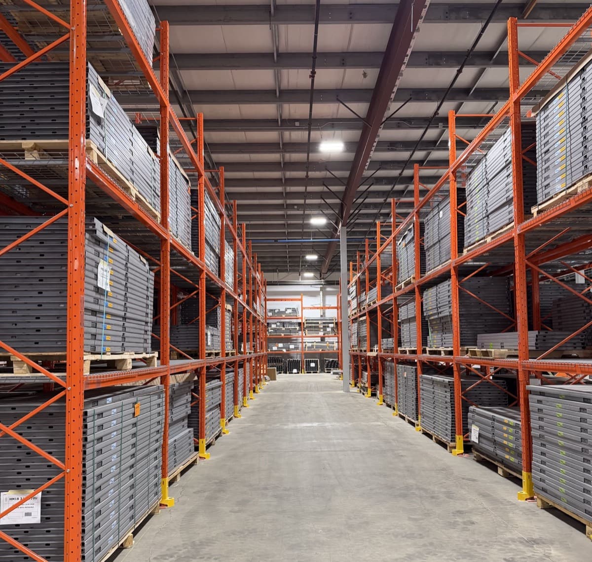 Wide warehouse aisle stocked with inventory